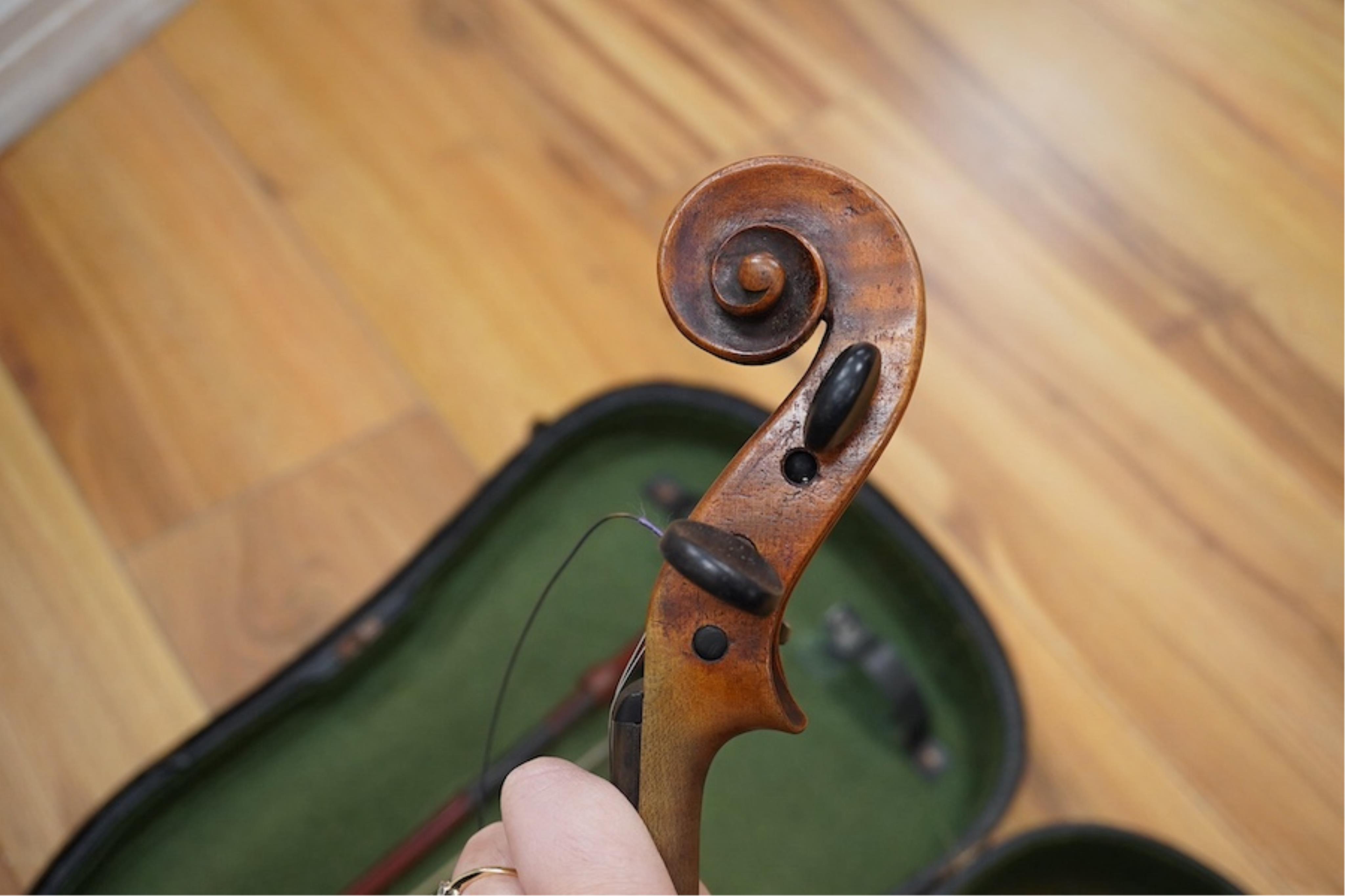 A late 19th cased century French unmarked violin and bow, body 35cm high.